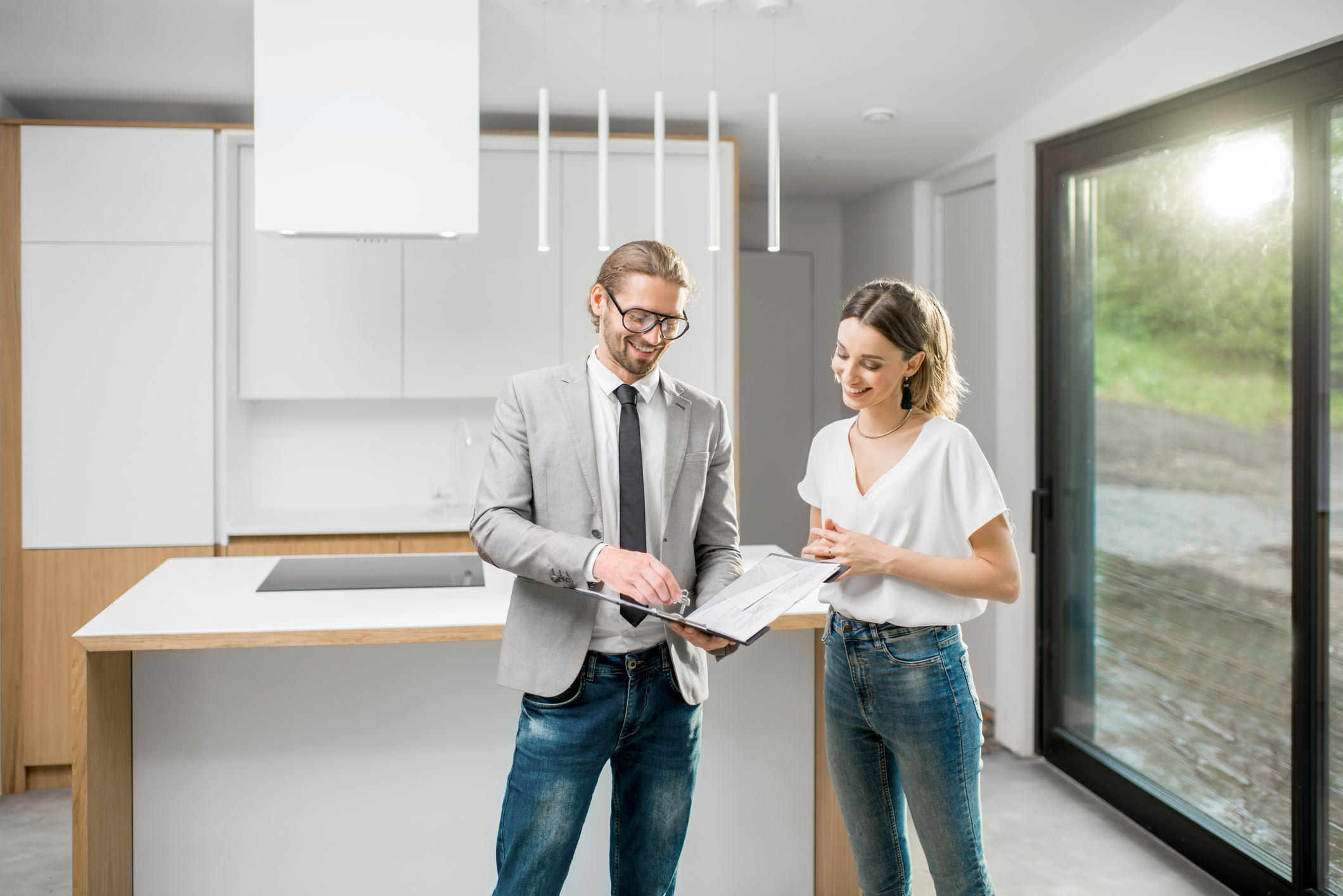 Happy homebuyer receiving house keys from real estate agent