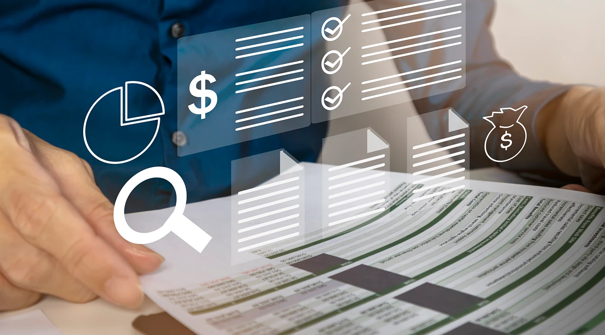 Person analyzing charts and financial reports.
