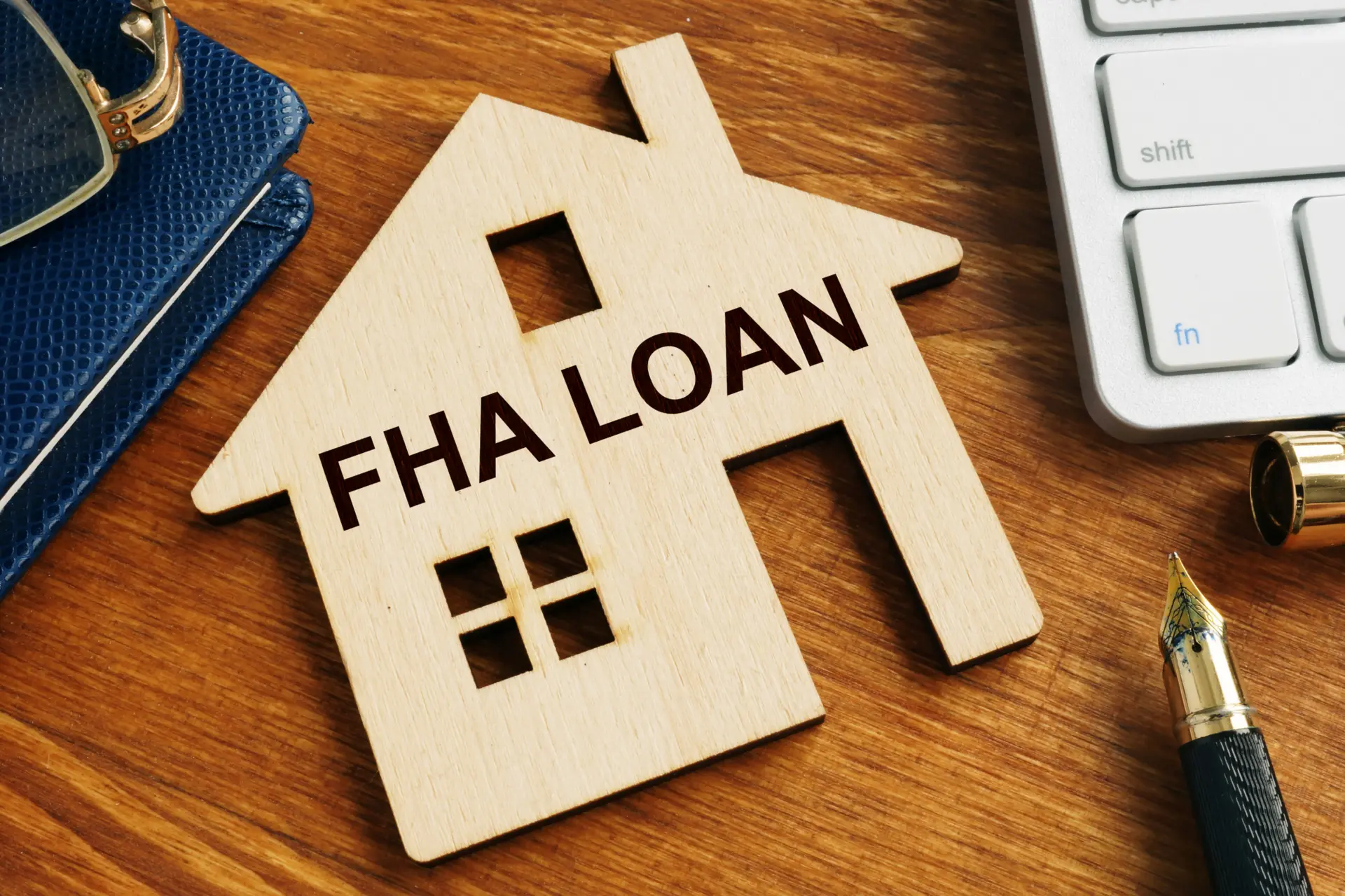 Wooden house cutout labeled FHA loan